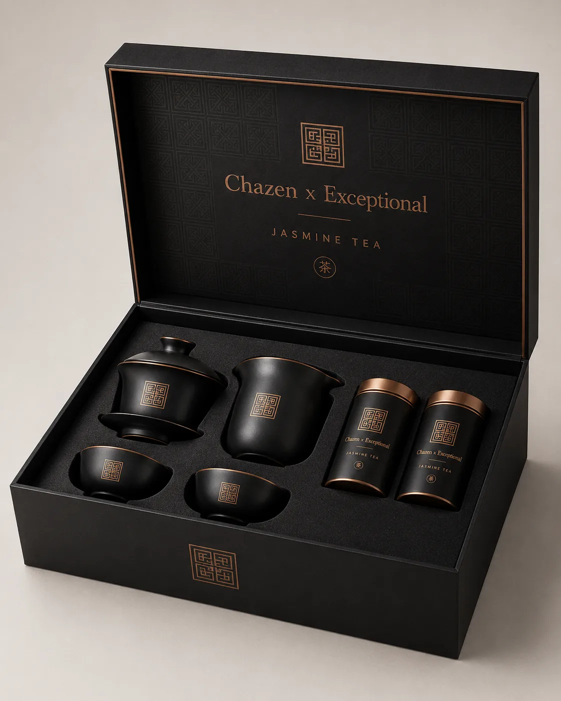A black presentation box with dark teaware and four tea canisters.