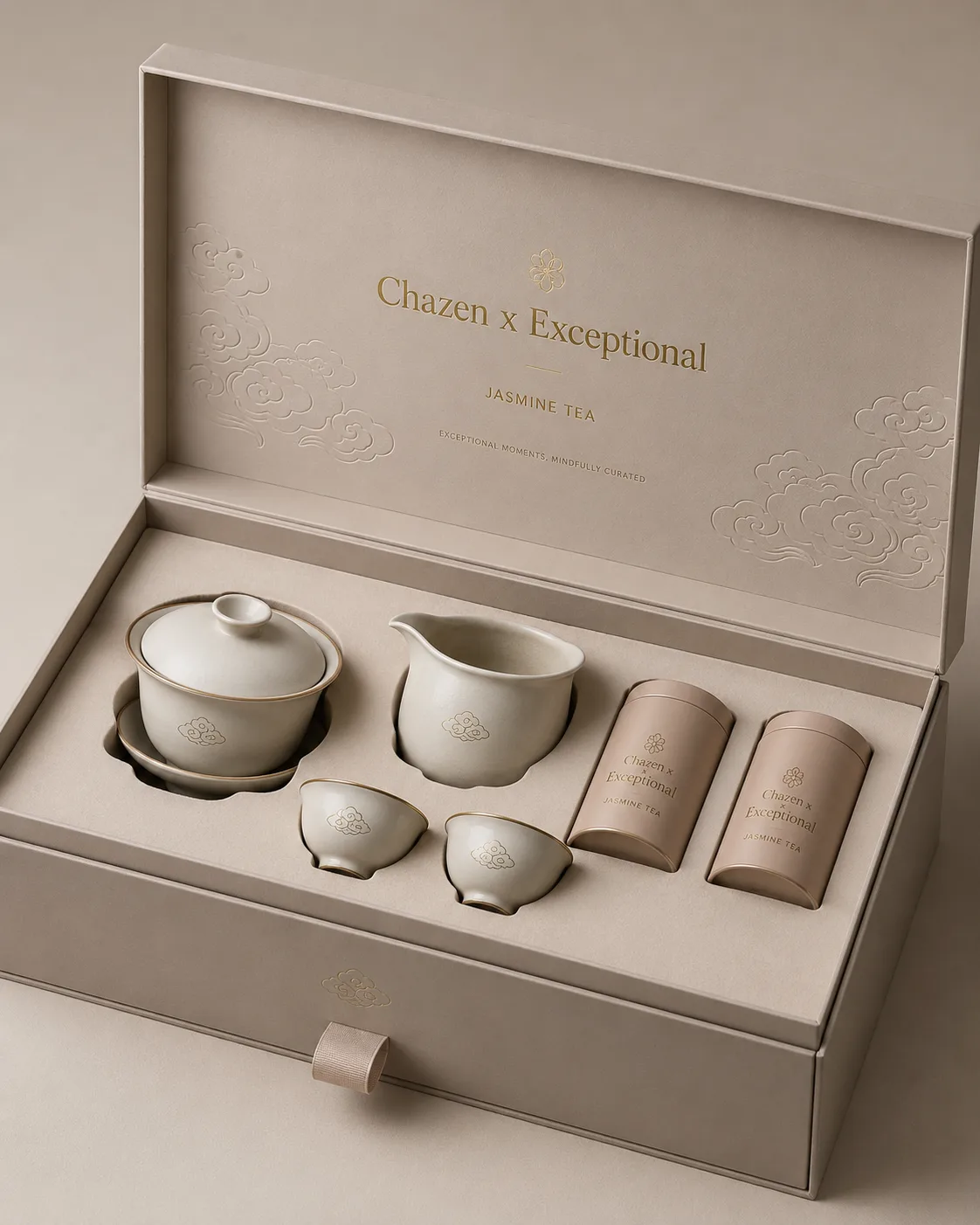 A warm ivory box containing a white tea set and woven tea accessories.