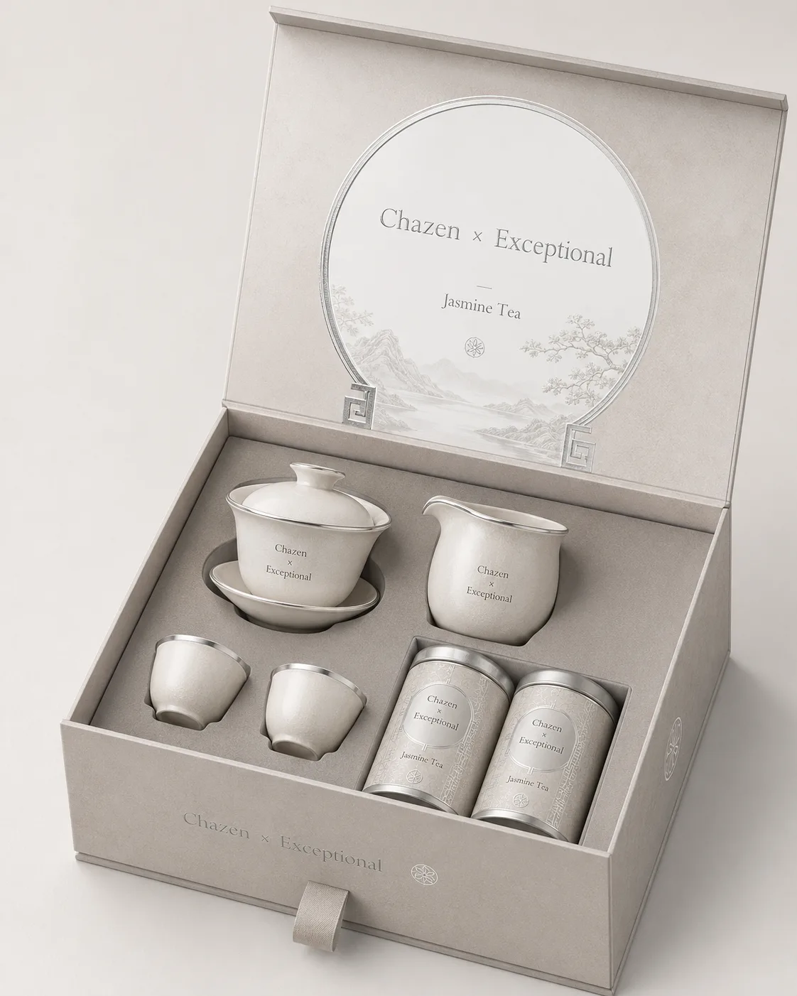 A pearl-white gift box holding white teaware and two tea canisters.