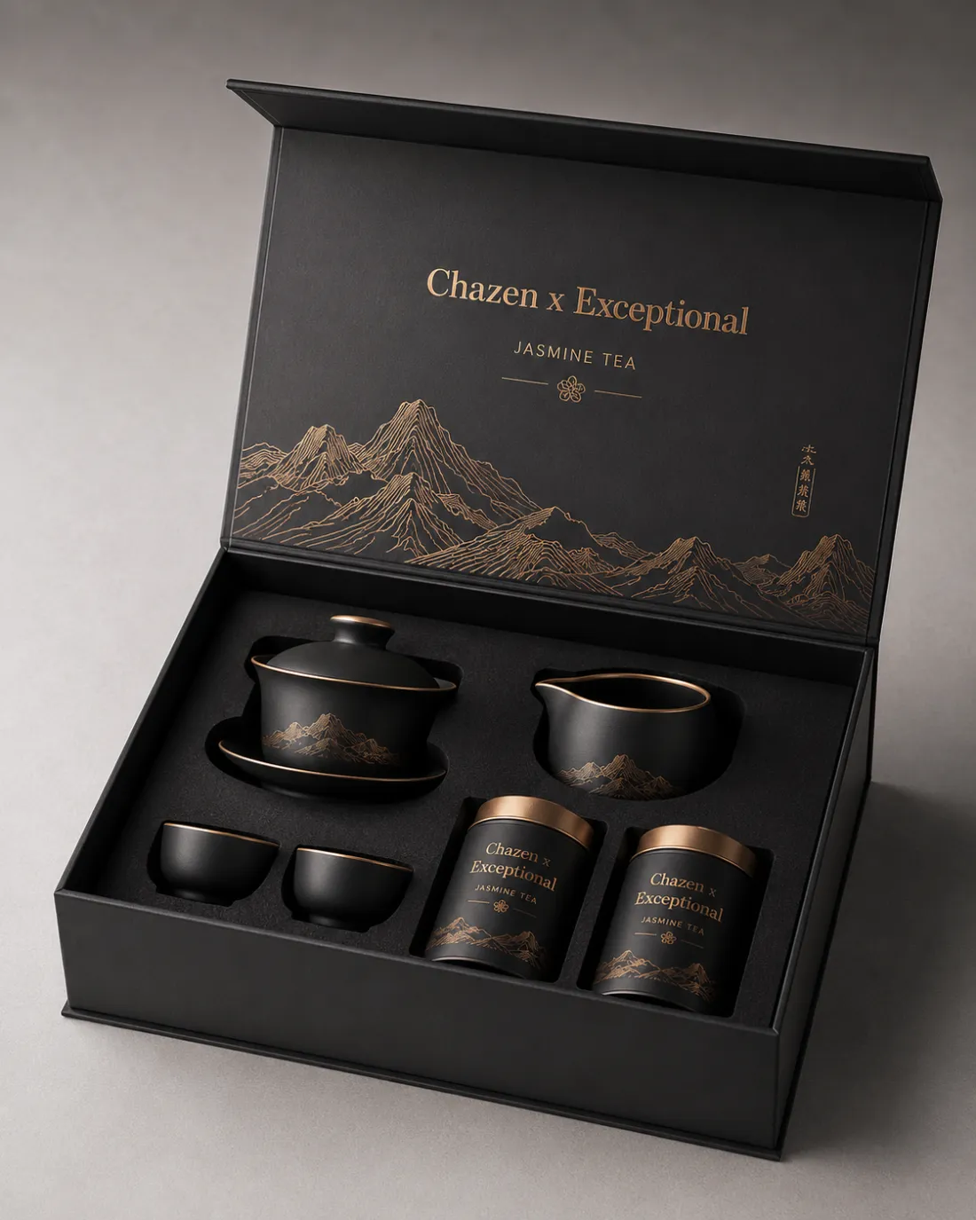 A black and gold Chazen gift set with a mountain motif, opened for a business handover.
