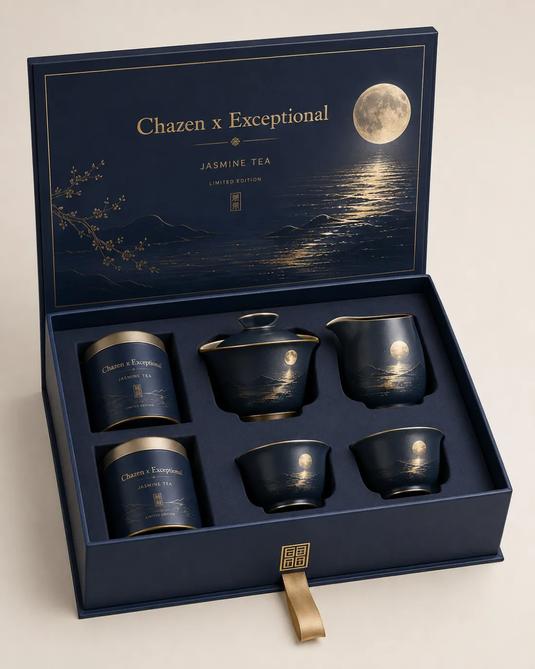 An open navy gift box; the lid is printed with a full moon over water and reads Chazen x Exceptional, Jasmine Tea, Limited Edition. Inside sit two sealed tins, a lidded gaiwan, a pitcher and two cups, all navy with gold rims.
