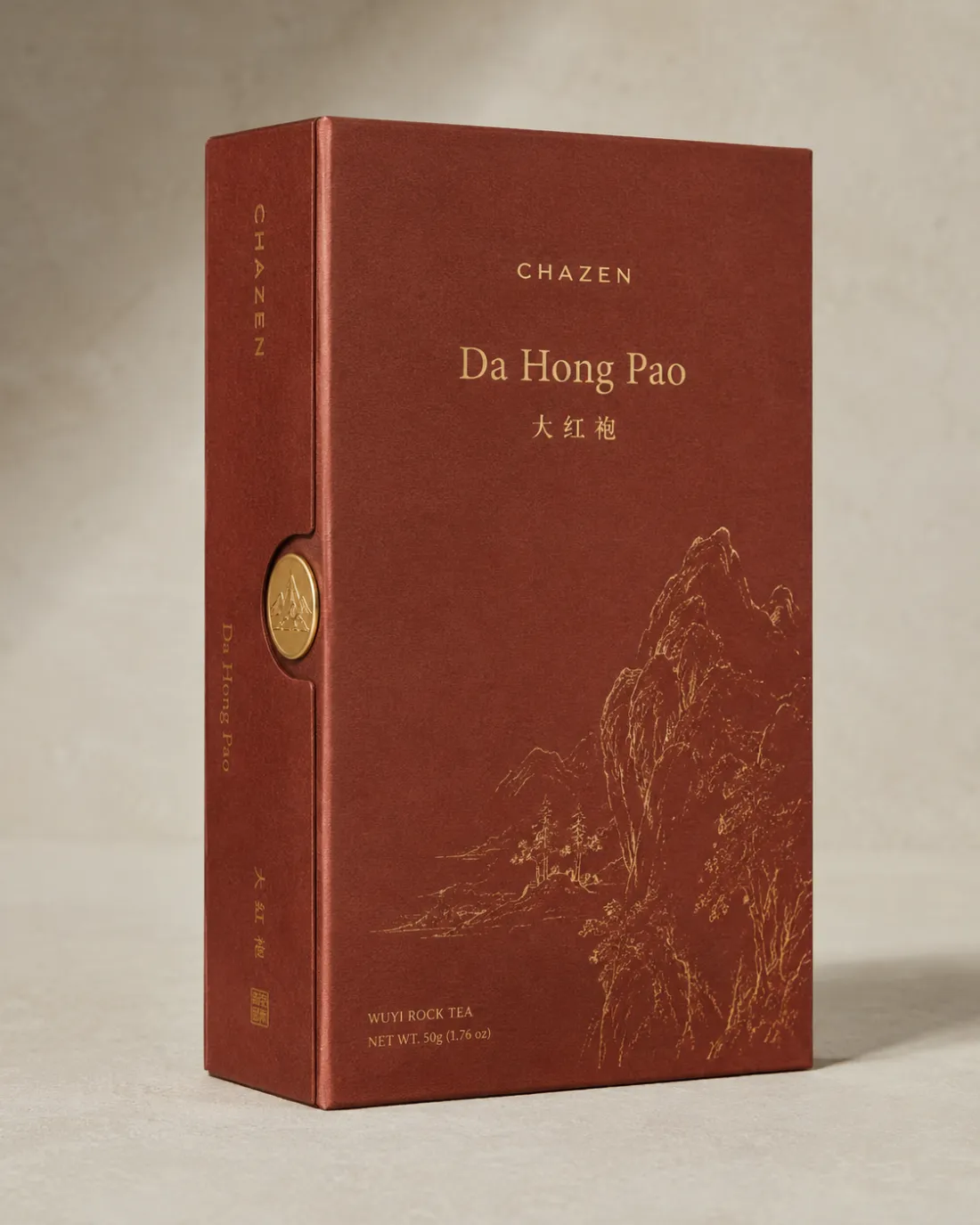 Oxblood Da Hong Pao carton with gold mountain line work and a gold seal disc on the spine