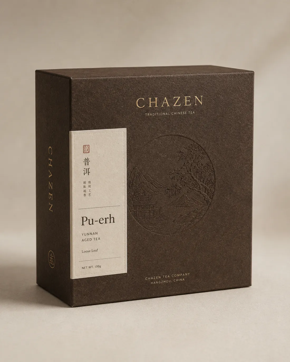 Dark brown Pu-erh box with a debossed circular pavilion scene and a pale paper label